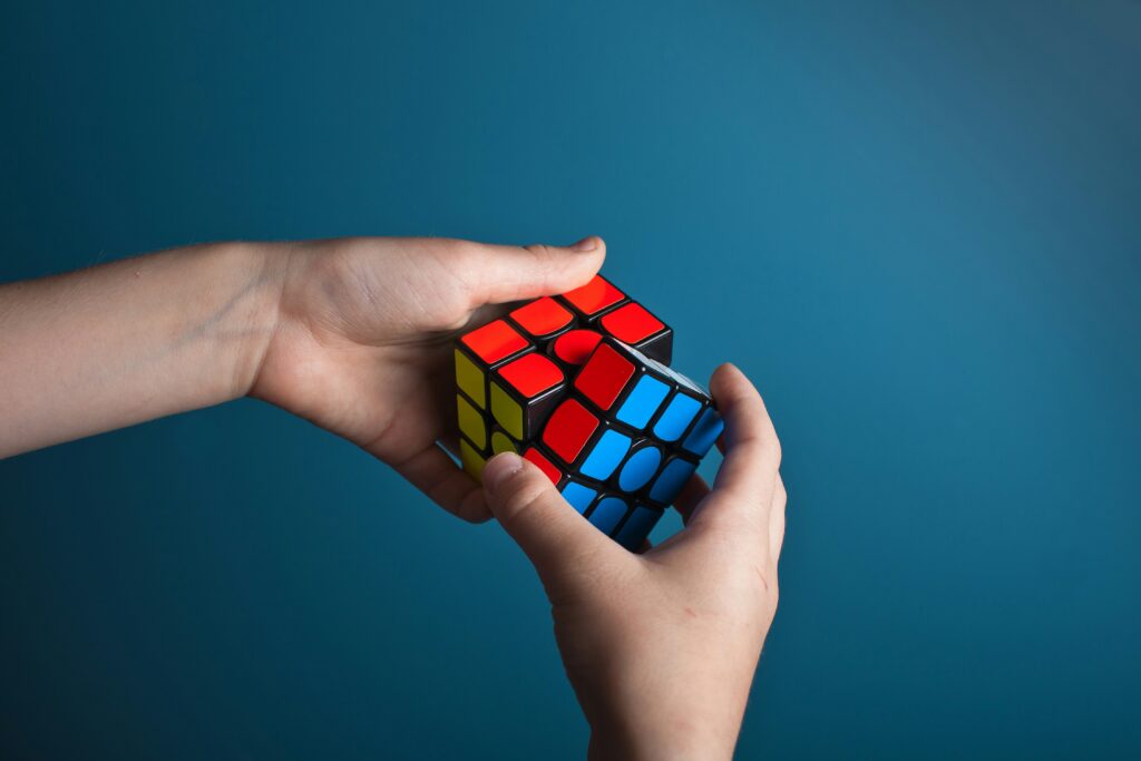a child's hands working a rubiks cube